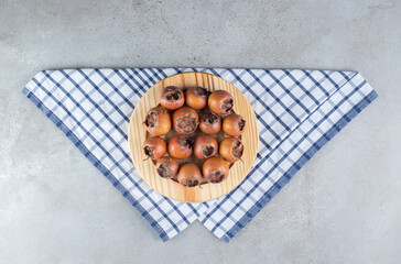 A wooden board with fresh juicy persimmons
