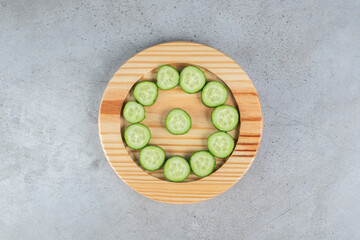 Fresh sliced cucumbers on a wooden board