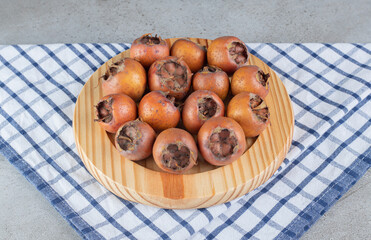 A wooden board with fresh juicy persimmons