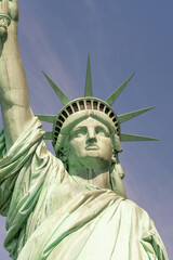 Close-up of the face and crown of the Statue of Liberty on a sunny day