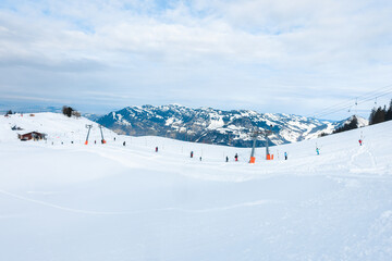 Fototapeta na wymiar People on ski drag lift rope in winter resort during holiday vacation