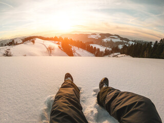 Pov of young man looking the sunset on snow high mountains - Winter vacation concept - Focus on his...