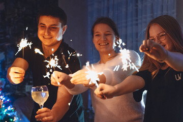 happy families of different ages cheering New Year's Eve at home. diverse cheerful friends with...