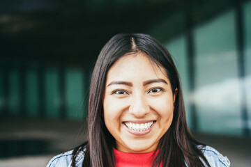 Young asian girl smiling on camera outdoor - Focus on face