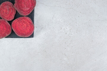 Sliced fresh beetroot vegetable on a dark board