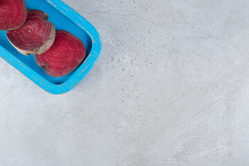 Sliced fresh beetroot vegetable on a blue board