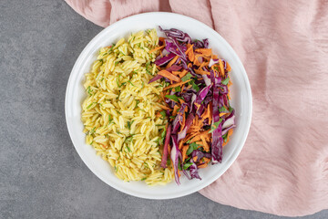 Steamed rice and vegetable salad on white plate