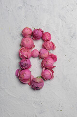 letter B outlined with pink flowers on a white background
