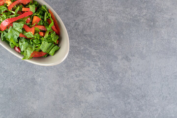 Bowl of vegetable salad on marble background