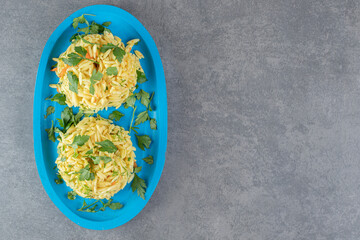 Two portions of delicious rice on blue plate