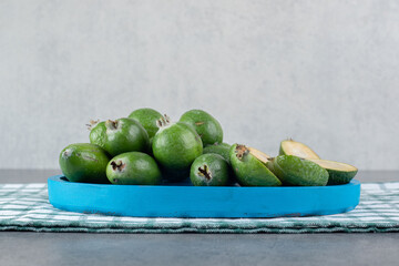 Ripe feijoa fruits on blue plate