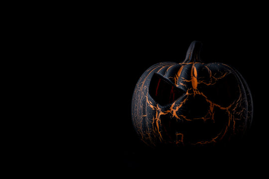 Black Halloween pumpkin on black background with Copyspace.