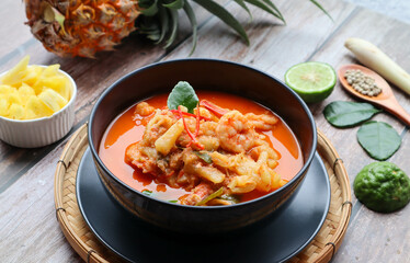 Pineapple and shrimp red curry - Thai authentic food called Kang Kua Supparos or Khang Kua at close up view