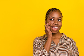 Photo of tricky cunning woman wear plaid shirt arm mouth looking empty space isolated yellow color...