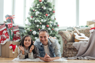 Fototapeta na wymiar father and daughter near the Christmas tree
