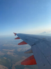 Fototapeta na wymiar Wing of airplane with beautiful sky and view