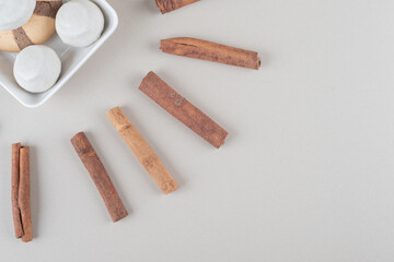 Arrangement of a cookie platter and cinnamon sticks on marble background