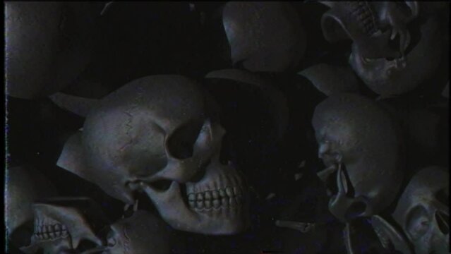 A camera span over an endless pile of black textured human skulls. The concept of death and horror. A bunch of skulls awesome halloween horror picture. Seamless loop 3d render