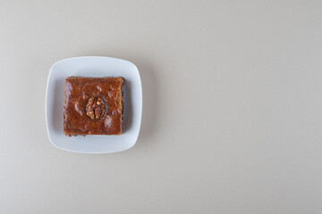 A small bakhlava on a platter on marble background