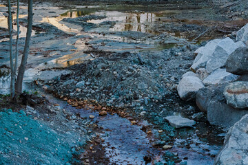 Close up view of a dry river with rest of mineral on the surface, copper and zinc with orange brown and blue color