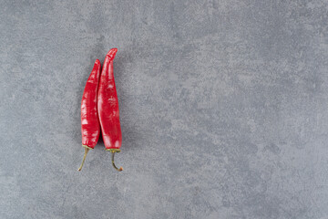 Red chili peppers on marble background