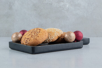 Cookies and baubles on a small tray on marble background