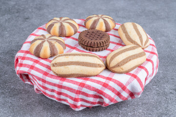 Assortment of sweet biscuits on striped tablecloth