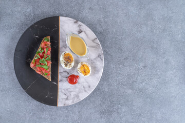 A marble plate with boiled egg and toast
