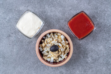 Delicious salad with mayonnaise and ketchup on a gray background
