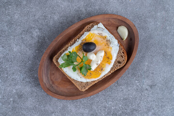 A wooden board of delicious toast with boiled egg