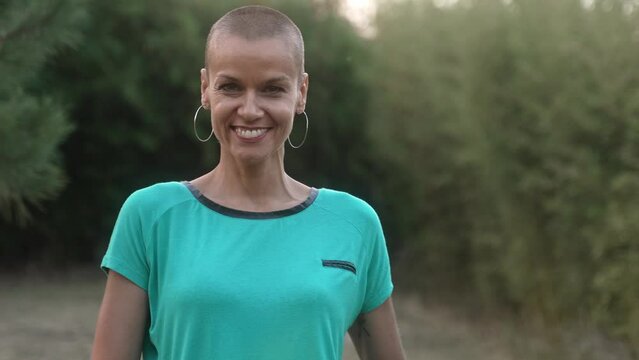 Positive powerful woman with shaved hair happy smiling looking to the camera - Human Emotions