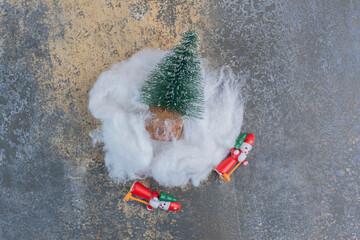 Two festive toys with Christmas tree and cotton wool