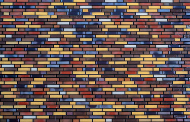 Background from wall of multicolored bricks
