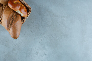 Various bread and pastry in wooden basket