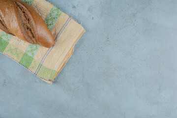 Brown delicious bread on colorful tablecloth