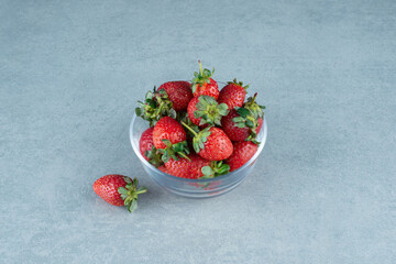 Fresh red strawberries in glass bowl