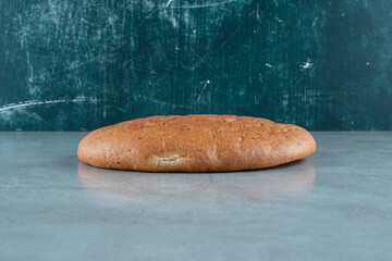 Brown delicious bread on marble background