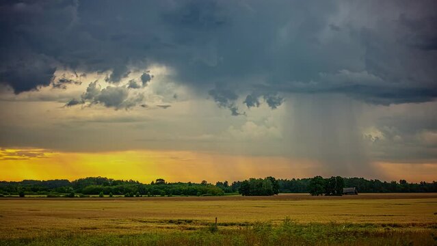 Time Lapse of Dark Rainy Clouds and Stormy Rainfall Above Rural Countryside Landscape
