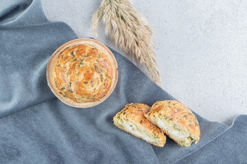 Sliced and whole sour gogals on tablecloth on marble background