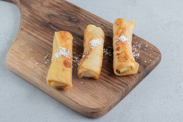 Pancakes on a wooden board on marble background