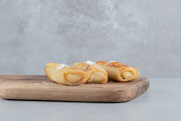 Pancakes on a wooden board on marble background