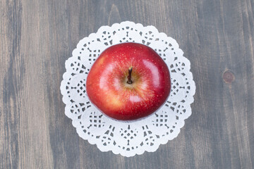 Whole fresh apple on wooden surface