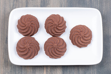Delicious cocoa biscuits on white plate