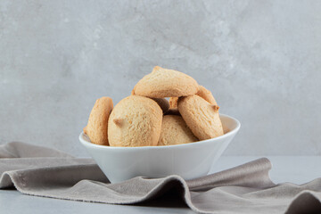 Pile of cookies in a bowl on marble background