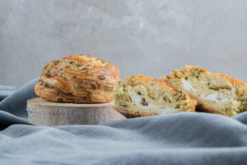 Sliced and whole sour gogals on tablecloth on marble background