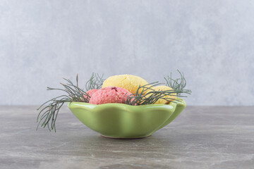 Pile of cookies in a small bowl on marble background