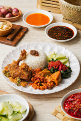 Ayam Goreng Padang. Traditional fried chicken with spice crumbs from Minangkabau, West Sumatra. served on white plate 