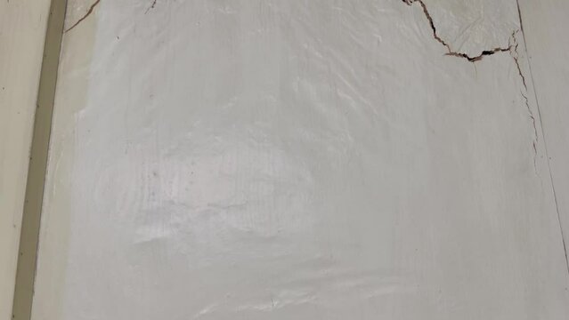 Panning view of the termites damage on the house wall