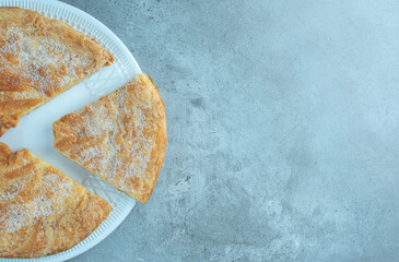 Sliced flaky flatbread on marble background