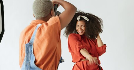 Happy model, photographer or photography with a black woman shooting for a professional fashion magazine photoshoot. Flash, beauty and fun or excited women working in a elegant or creative art studio